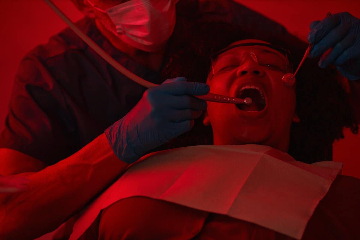 dentist-examining-patient-s-mouth