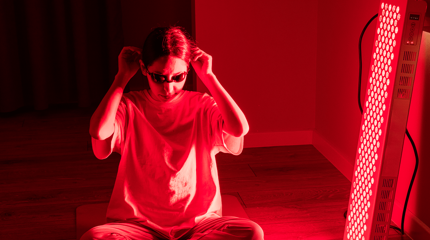 woman-adjusting-eye-protection-for-red-light-therapy
