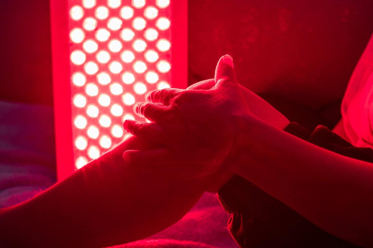 closeup-of-sore-leg-of-a-person-treating-with-red-light-therapy
